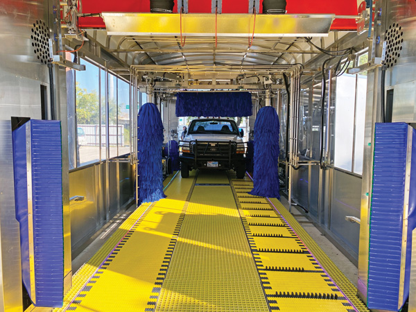 Truck inside a car wash on a belt conveyor